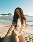 cream Hand crochet one piece bathing suit
Halter-tie and cheeky cutouts
Tie-front center detail
Thong coverage