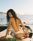cream Hand crochet one piece bathing suit
Halter-tie and cheeky cutouts
Tie-front center detail
Thong coverage