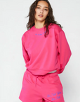 Graphic printed knit sweatshirt. Cropped fit. Unlined. Pink cropped oversized sweater. Airport outfit. Loungewear. Relaxing outfit.