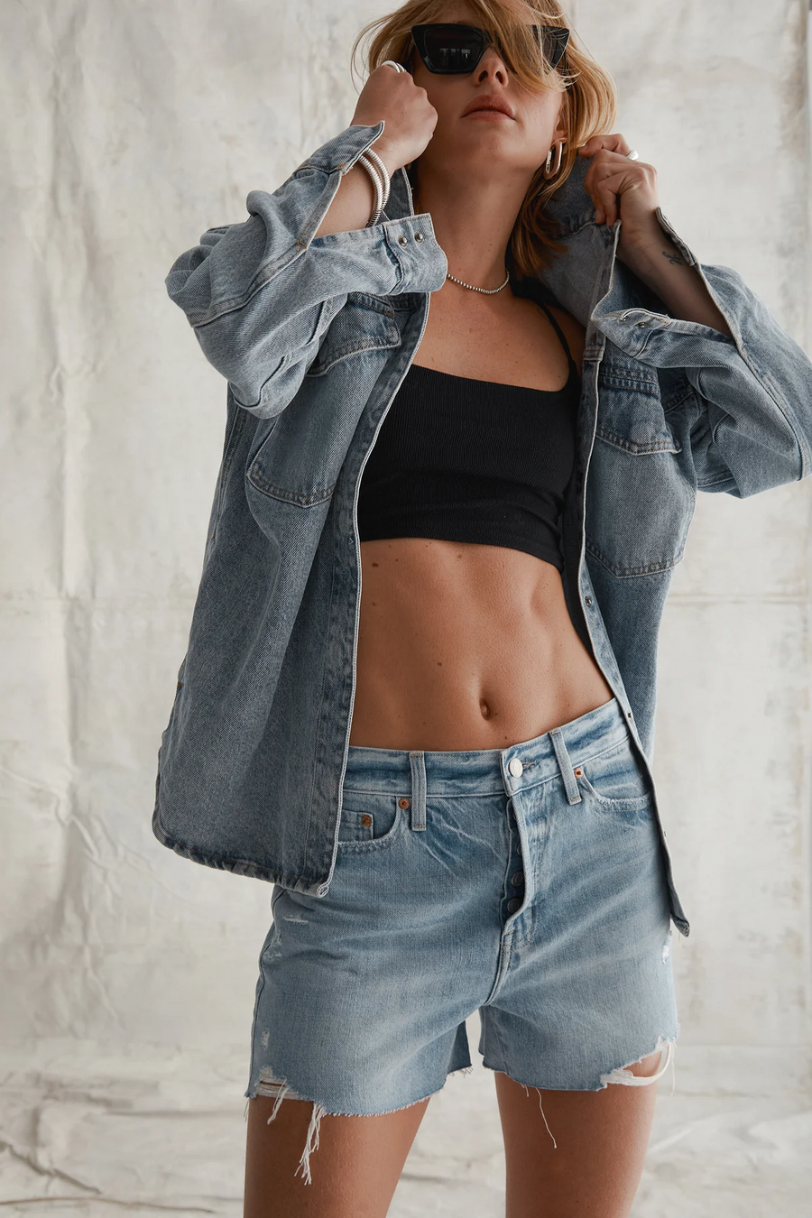 Relaxed high rise vintage shorts. Button fly closure. Distressed. Unlined. No stretch. light wash denim shorts. frayed shorts. mid to high rise shorts