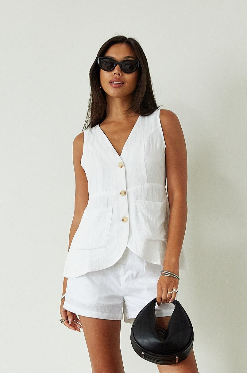 Woven sleeveless top. Front button down closure. Front pockets. Fully lined. white vest top. summer top. summer outfit. cute casual. cute but comfy top