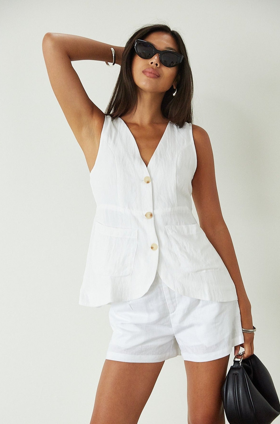 Woven sleeveless top. Front button down closure. Front pockets. Fully lined. white vest top. summer top. summer outfit. cute casual. cute but comfy top