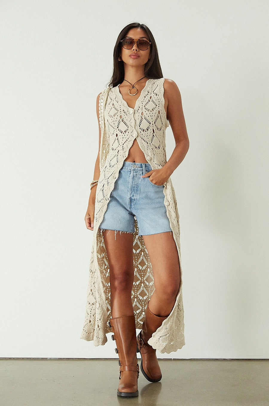 Relax fit mid-length denim shorts. Button fly. Five pocket construction. Raw hem. Unlined. denim shorts. light wash denim shorts. medium wash denim shorts