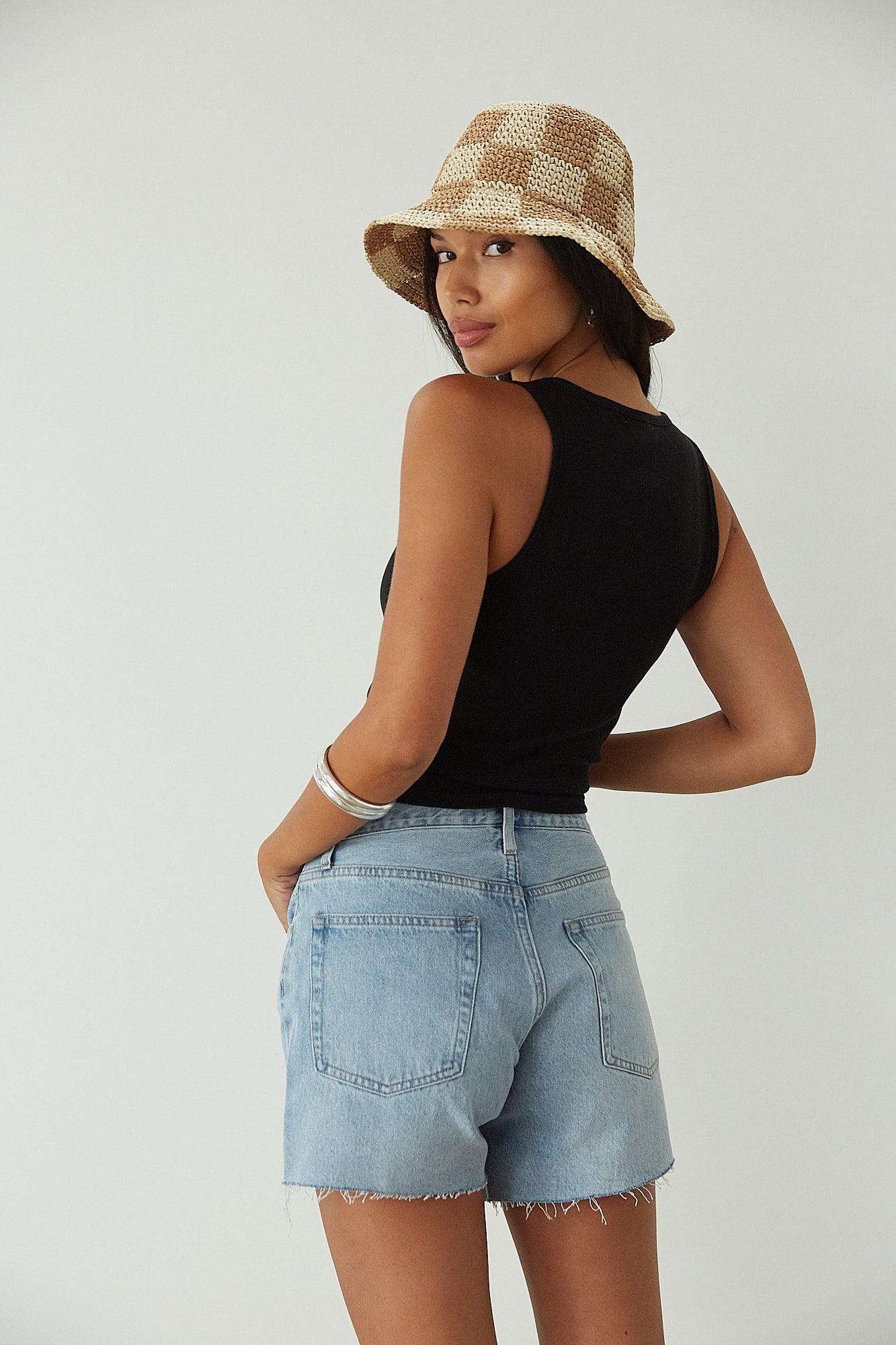 Relax fit mid-length denim shorts. Button fly. Five pocket construction. Raw hem. Unlined. denim shorts. light wash denim shorts. medium wash denim shorts