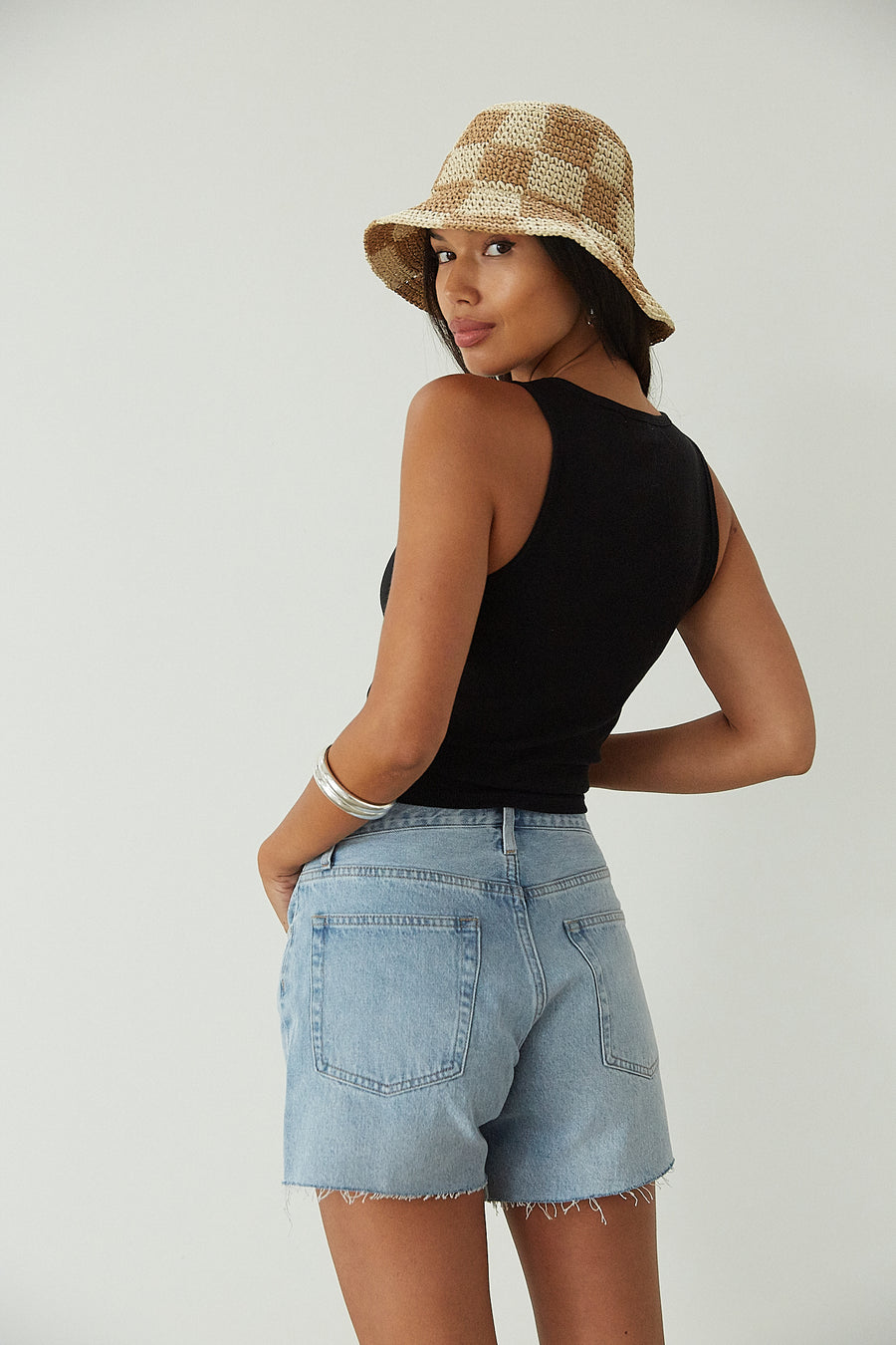 Relax fit mid-length denim shorts. Button fly. Five pocket construction. Raw hem. Unlined. denim shorts. light wash denim shorts. medium wash denim shorts
