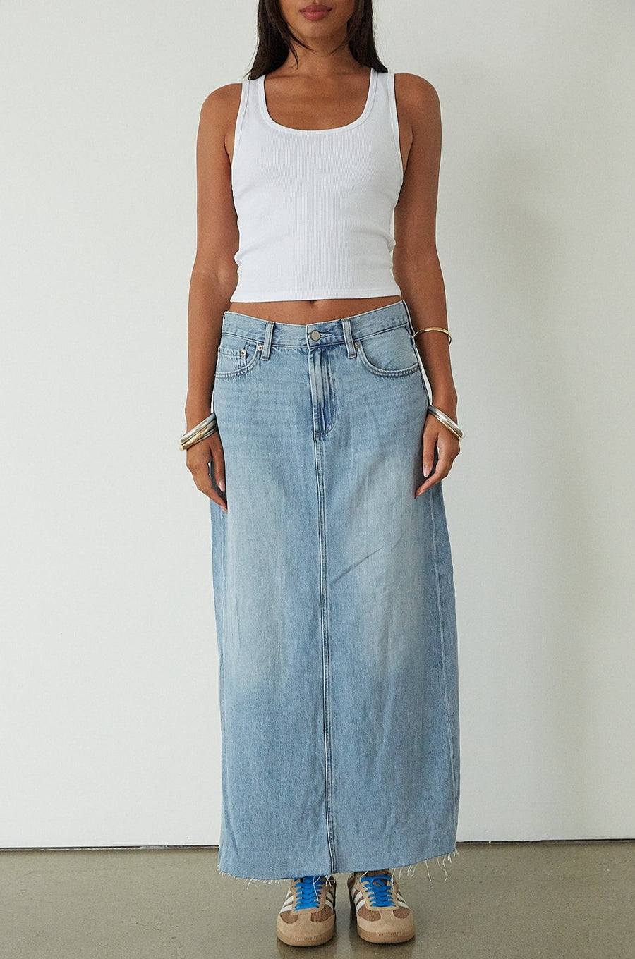Denim maxi skirt. Button and zipper fly. Five pocket construction. Back slit. Raw hem. Unlined. blue denim maxi skirt. denim maxi skirt with back slit. summer outfit. casual outfit. cute casual outfit. 