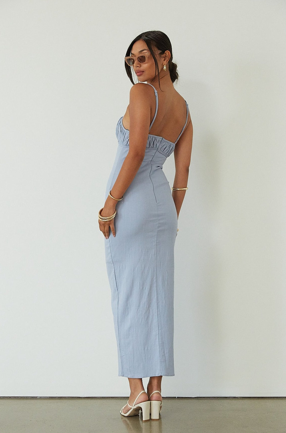 Knit maxi dress. Adjustable straps. Ruched bust. Back hook and eye and zipper closures. Partially lined. blue maxi dress. wedding guest dress. summer maxi dress