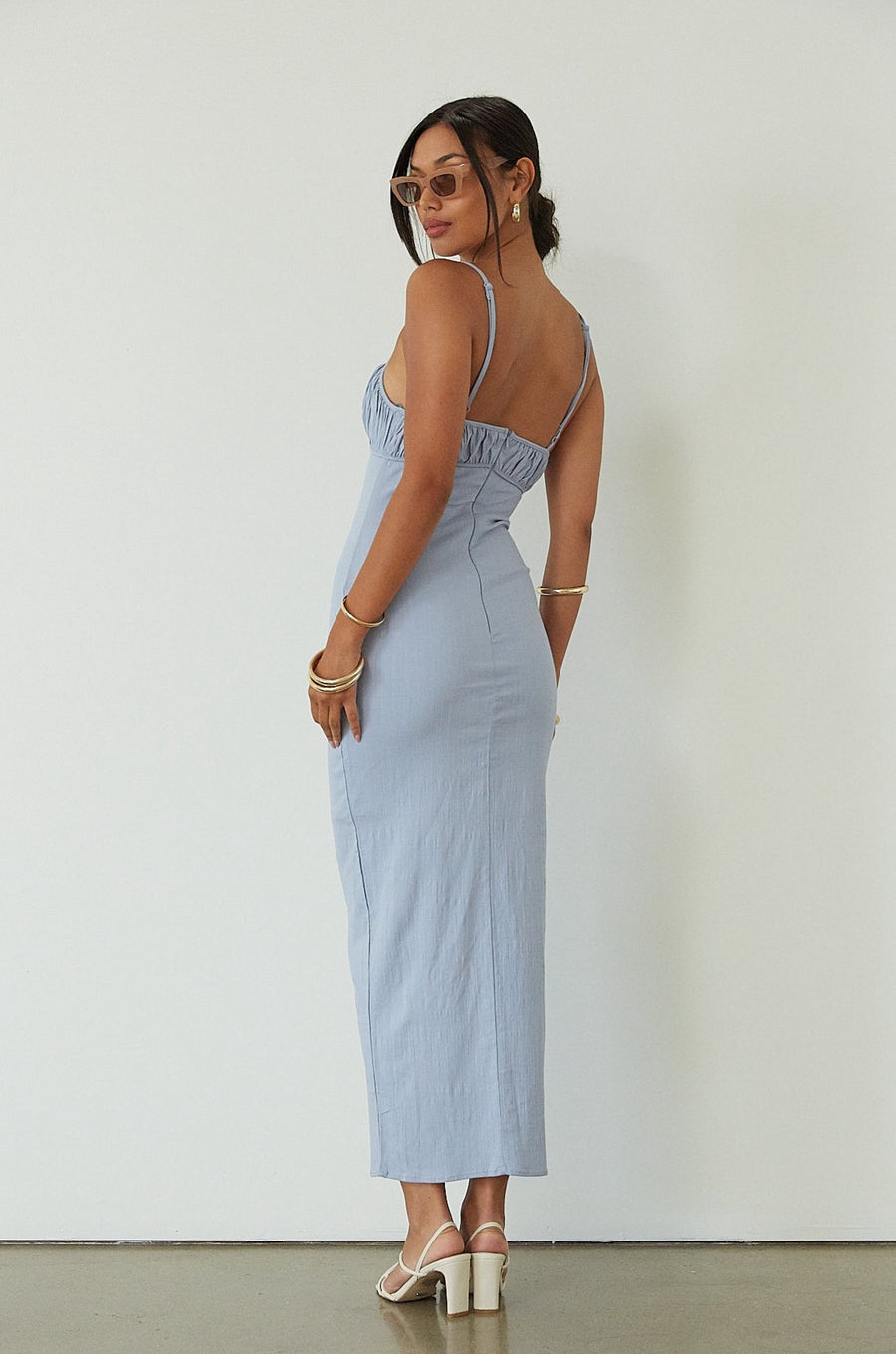 Knit maxi dress. Adjustable straps. Ruched bust. Back hook and eye and zipper closures. Partially lined. blue maxi dress. wedding guest dress. summer maxi dress