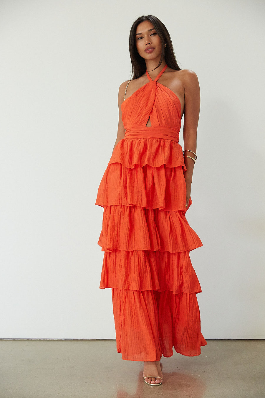 Crinkle woven tiered maxi dress. Adjustable halter tie neckline. Back hook and eye and zipper closures. Fully lined. orange maxi dress. wedding guest dress. evening dress. vacation dress. fancy dinner dress