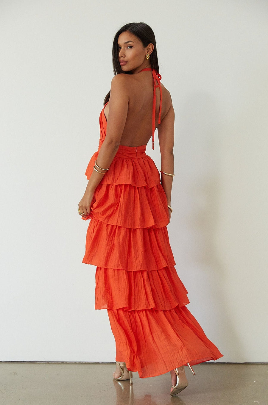 Crinkle woven tiered maxi dress. Adjustable halter tie neckline. Back hook and eye and zipper closures. Fully lined. orange maxi dress. wedding guest dress. evening dress. vacation dress. fancy dinner dress