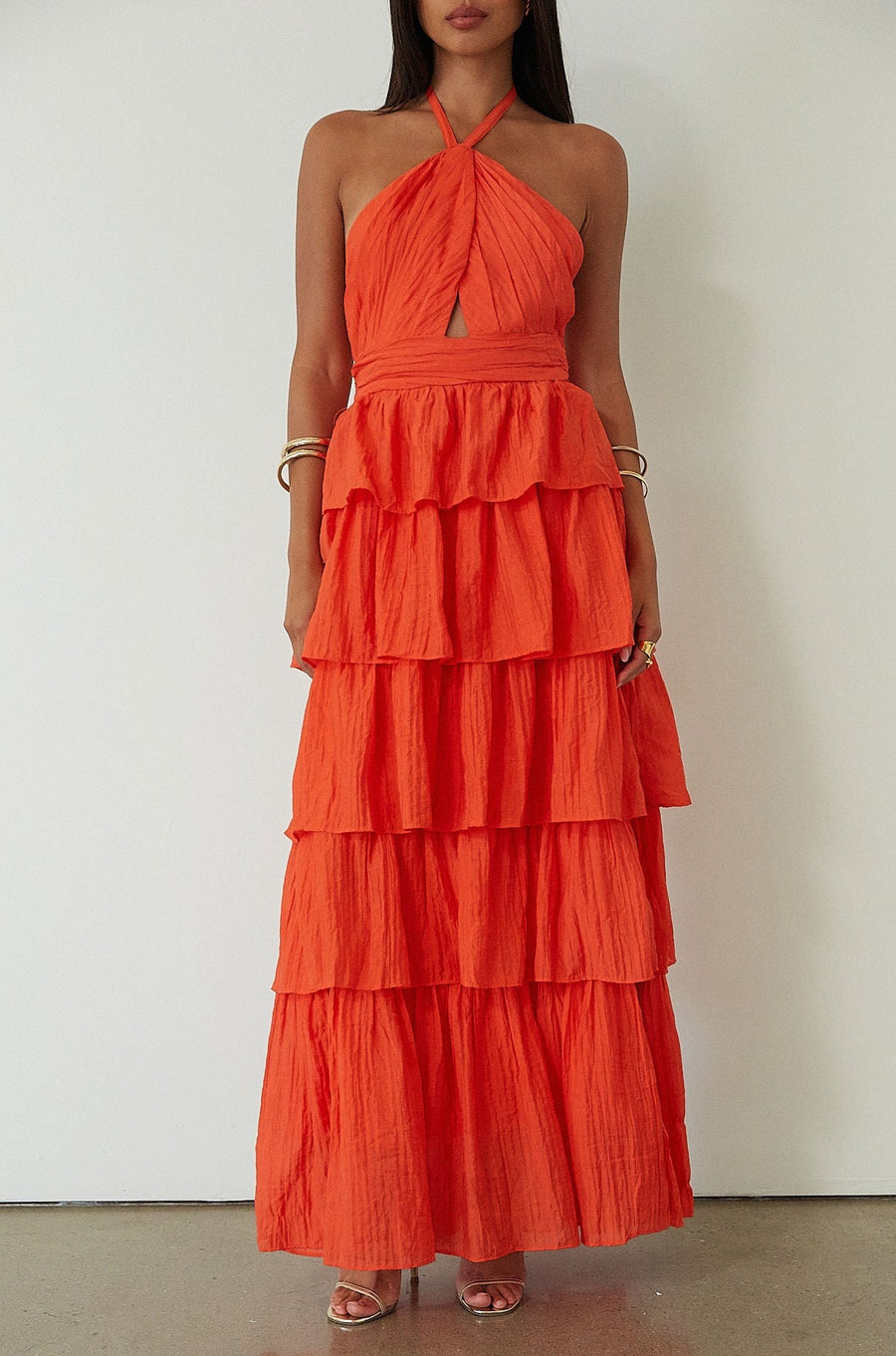 Crinkle woven tiered maxi dress. Adjustable halter tie neckline. Back hook and eye and zipper closures. Fully lined. orange maxi dress. wedding guest dress. evening dress. vacation dress. fancy dinner dress