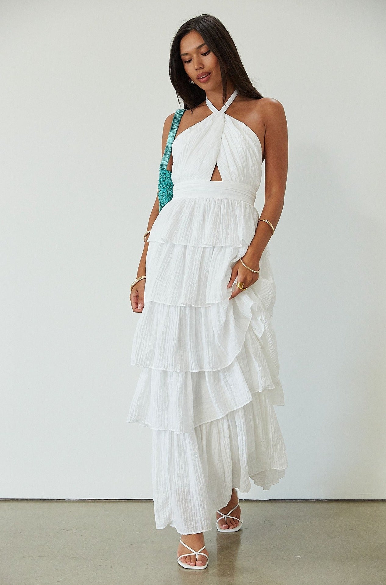 Crinkle woven tiered maxi dress. Adjustable halter tie neckline. Back hook and eye and zipper closures. Fully lined. white maxi dress. wedding guest dress. evening dress. vacation dress. fancy dinner dress. engagement dress. bridal shower dress.