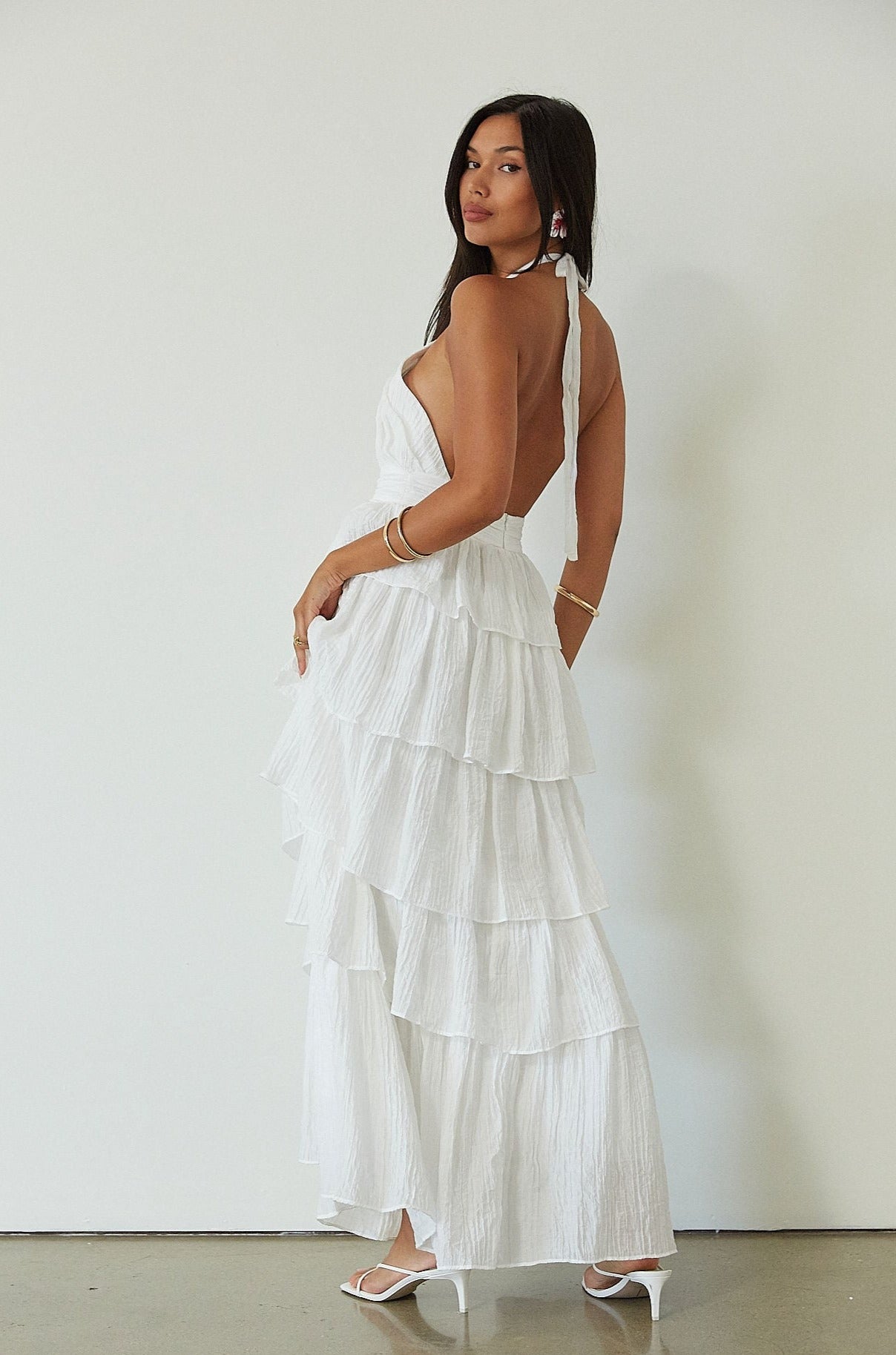 Crinkle woven tiered maxi dress. Adjustable halter tie neckline. Back hook and eye and zipper closures. Fully lined. white maxi dress. wedding guest dress. evening dress. vacation dress. fancy dinner dress. engagement dress. bridal shower dress.