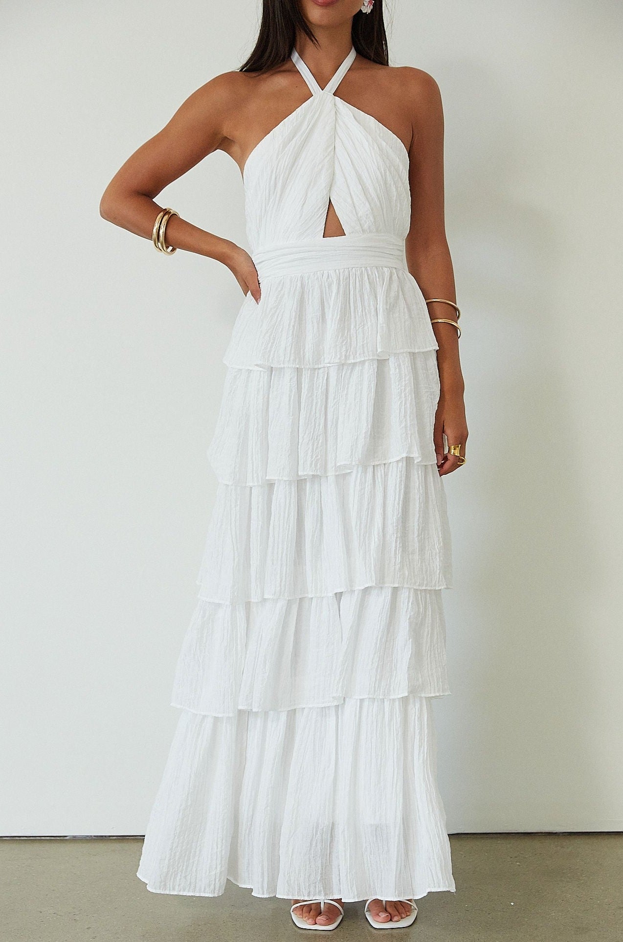 Crinkle woven tiered maxi dress. Adjustable halter tie neckline. Back hook and eye and zipper closures. Fully lined. white maxi dress. wedding guest dress. evening dress. vacation dress. fancy dinner dress. engagement dress. bridal shower dress.