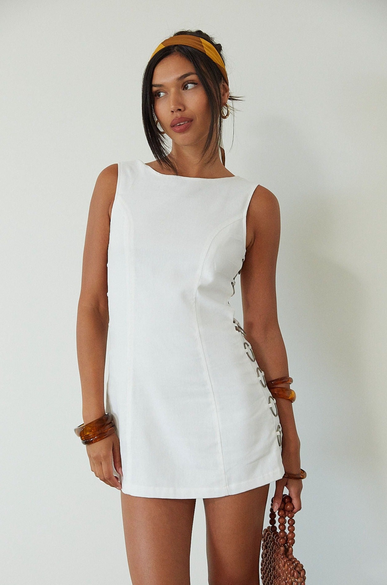 Woven sleeveless dress. Side ring details. Back zipper closure. Fully lined. white mini dress. high neck line mini dress. summer dress. engagement dress. bridal shower dress. 