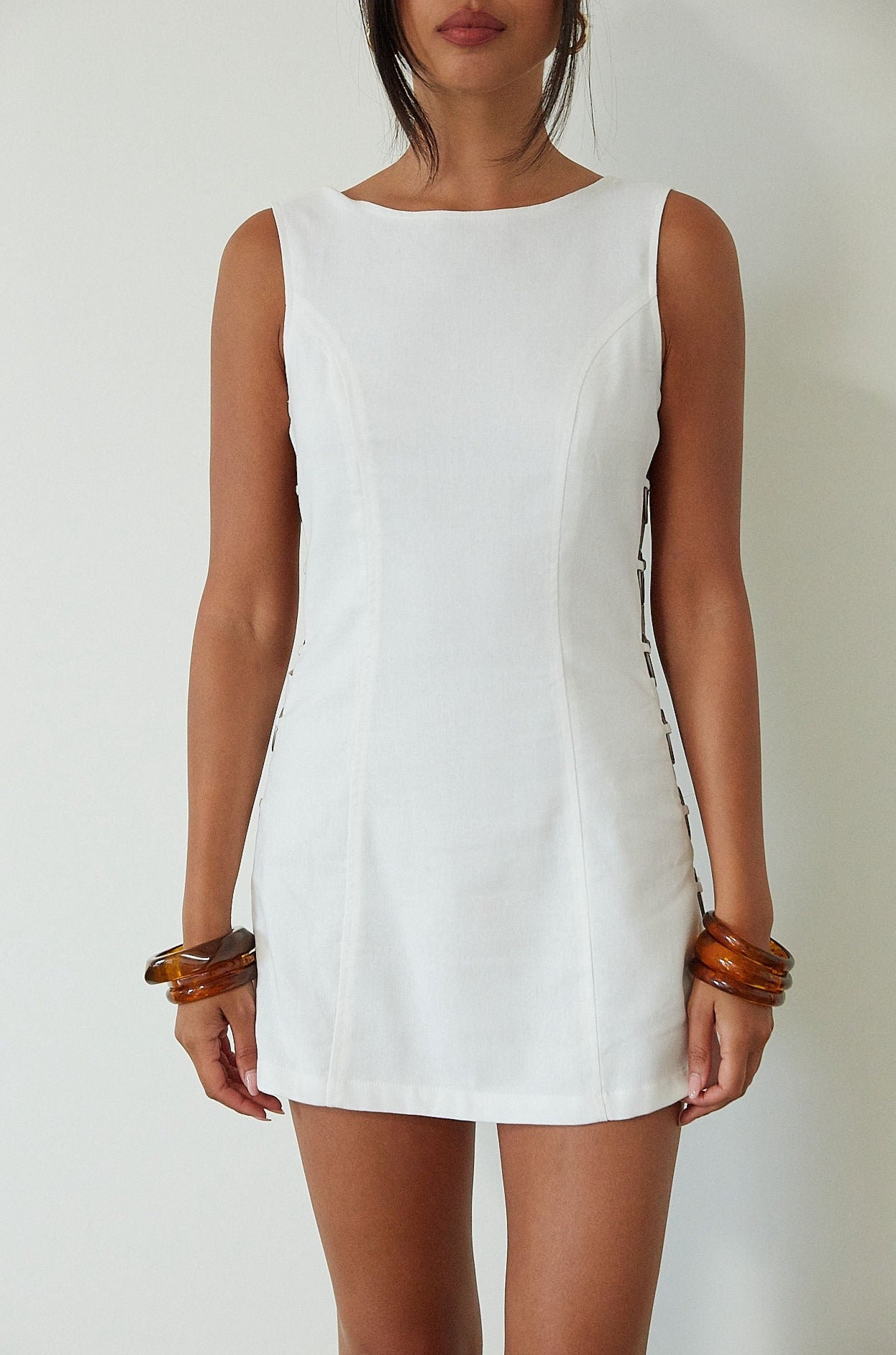 Woven sleeveless dress. Side ring details. Back zipper closure. Fully lined. white mini dress. high neck line mini dress. summer dress. engagement dress. bridal shower dress. 