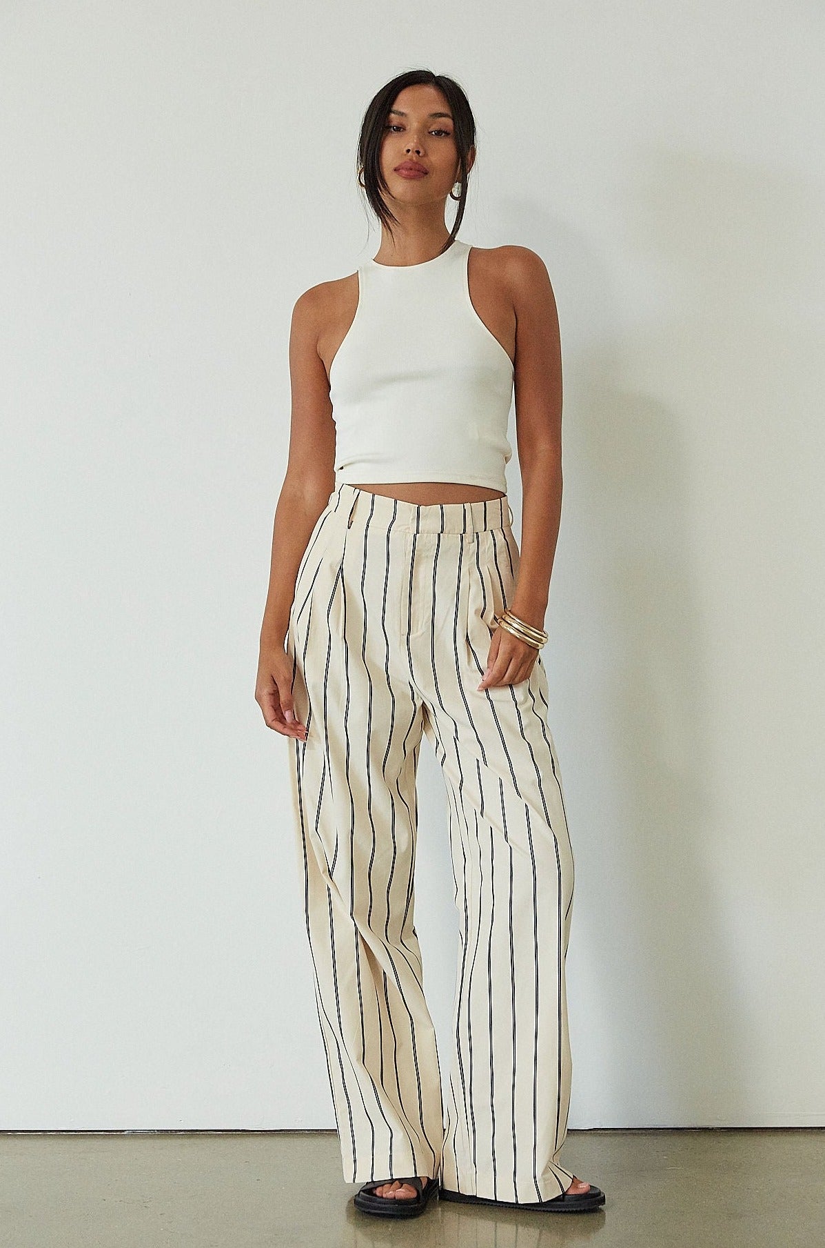 Striped woven pants. Hook and eye and zipper fly. Side pockets. Unlined. beige striped pant. work pant. casual work pant. vacation outfit. vacation pant. 