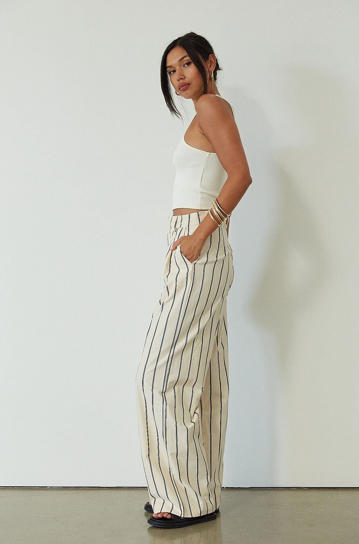 Striped woven pants. Hook and eye and zipper fly. Side pockets. Unlined. beige striped pant. work pant. casual work pant. vacation outfit. vacation pant. 