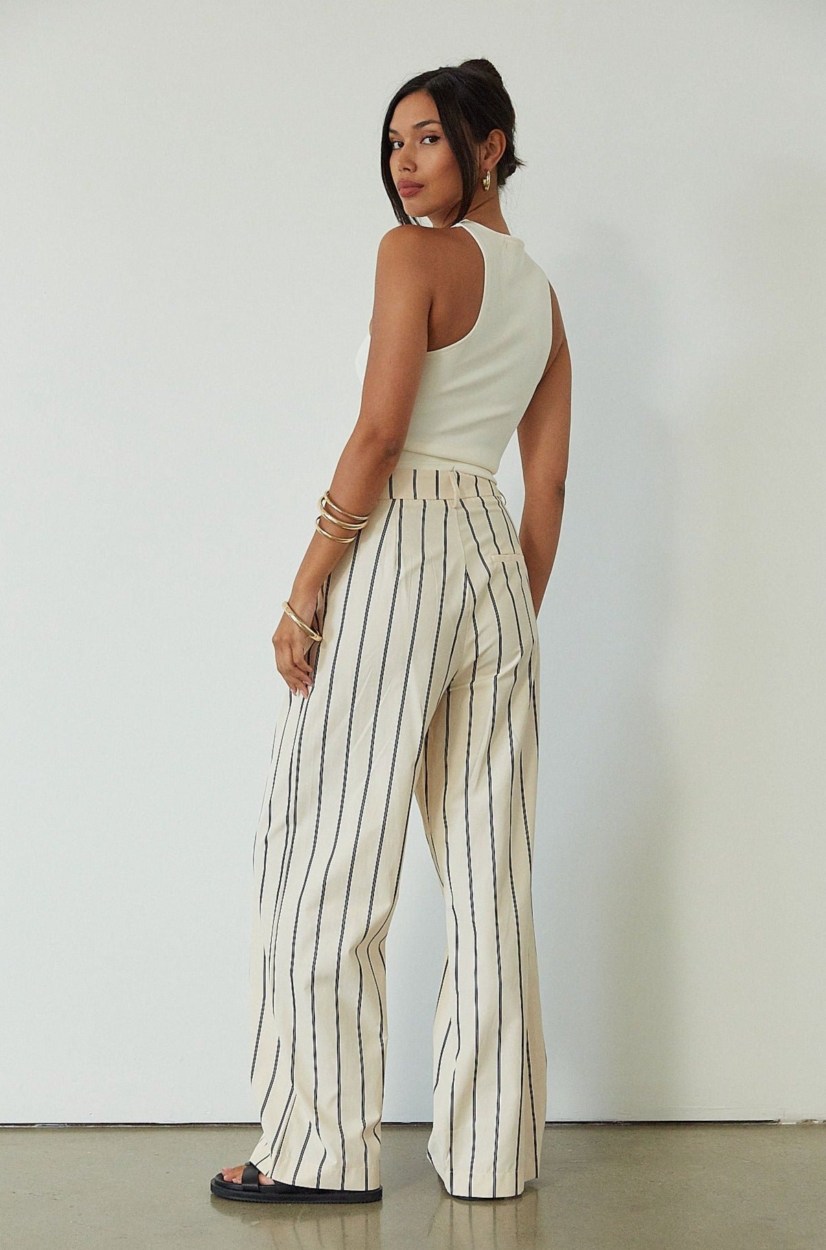 Striped woven pants. Hook and eye and zipper fly. Side pockets. Unlined. beige striped pant. work pant. casual work pant. vacation outfit. vacation pant. 
