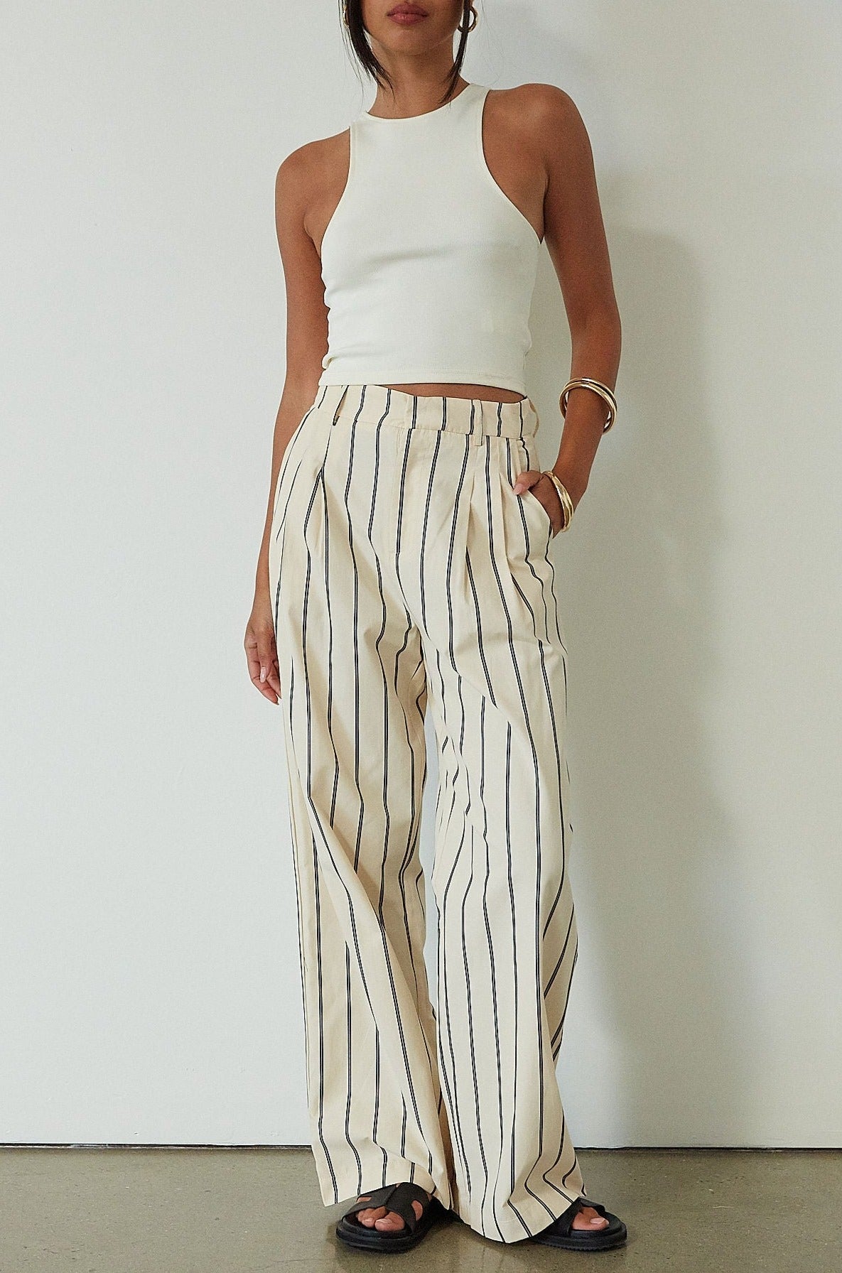 Striped woven pants. Hook and eye and zipper fly. Side pockets. Unlined. beige striped pant. work pant. casual work pant. vacation outfit. vacation pant. 