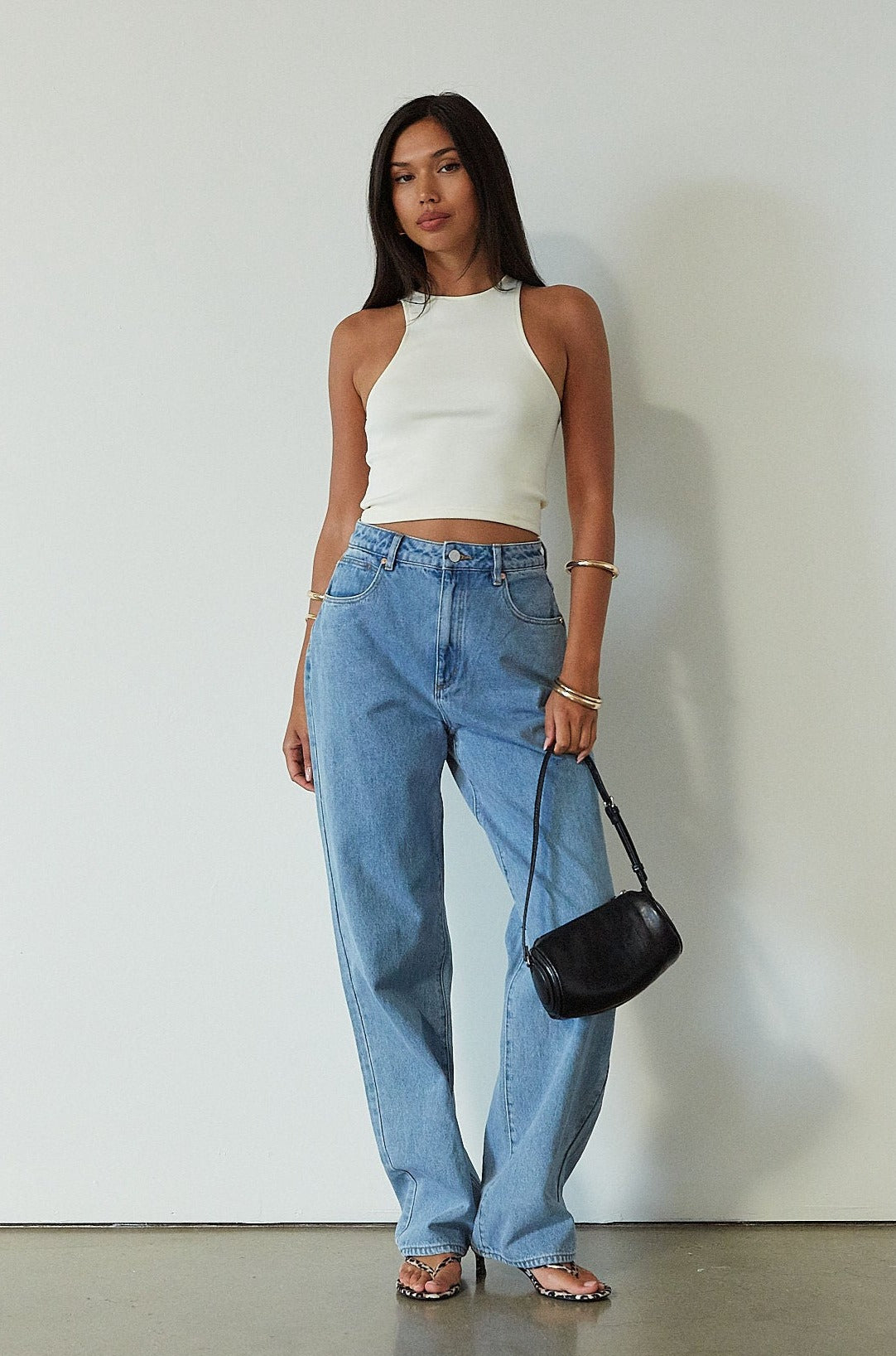 Denim relaxed fit jeans. Button and zipper fly. Five pocket construction. Unlined. mid wash denim jeans.