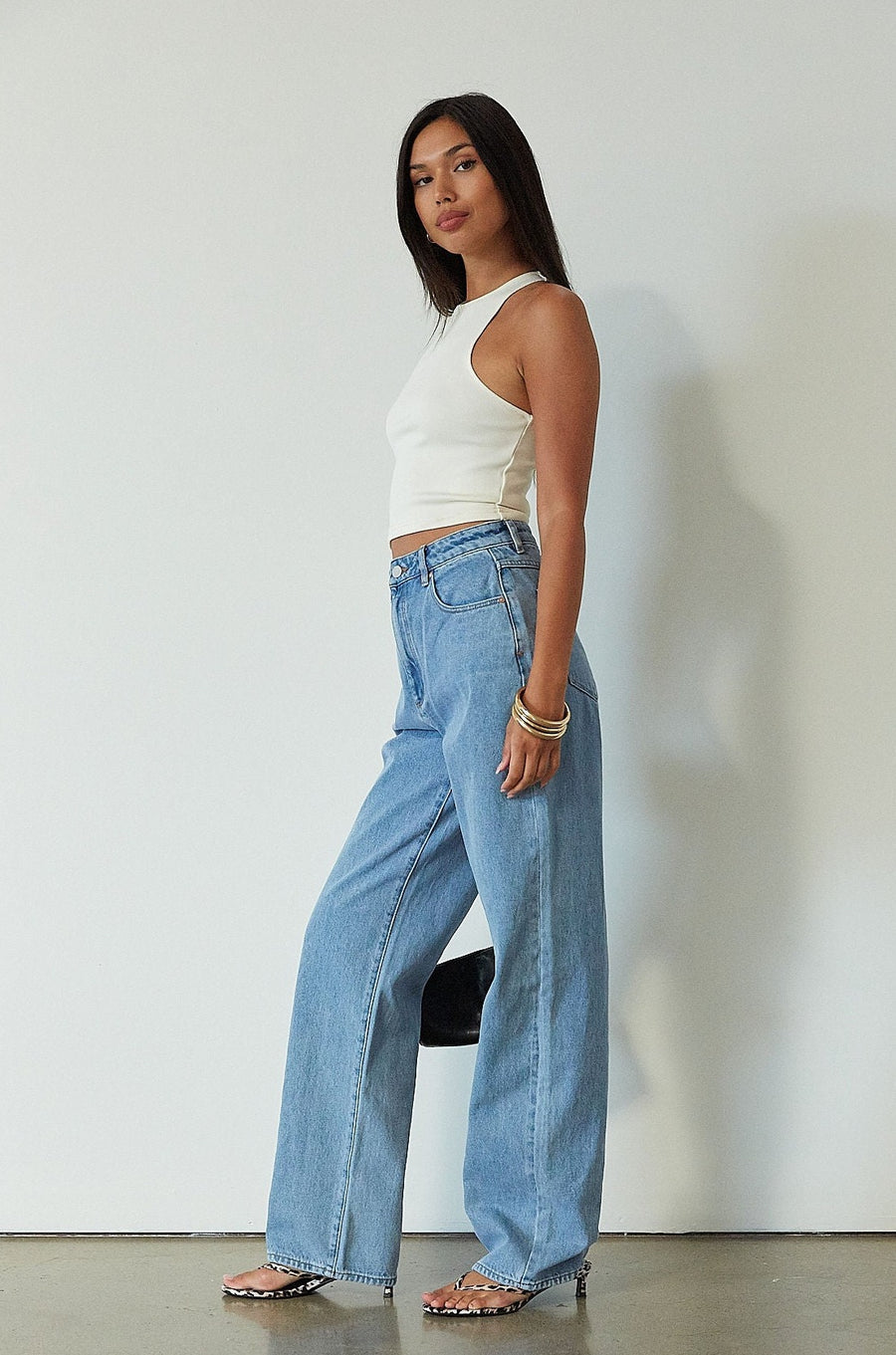 Denim relaxed fit jeans. Button and zipper fly. Five pocket construction. Unlined. mid wash denim jeans.