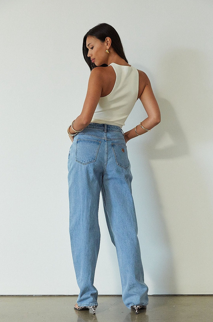 Denim relaxed fit jeans. Button and zipper fly. Five pocket construction. Unlined. mid wash denim jeans.