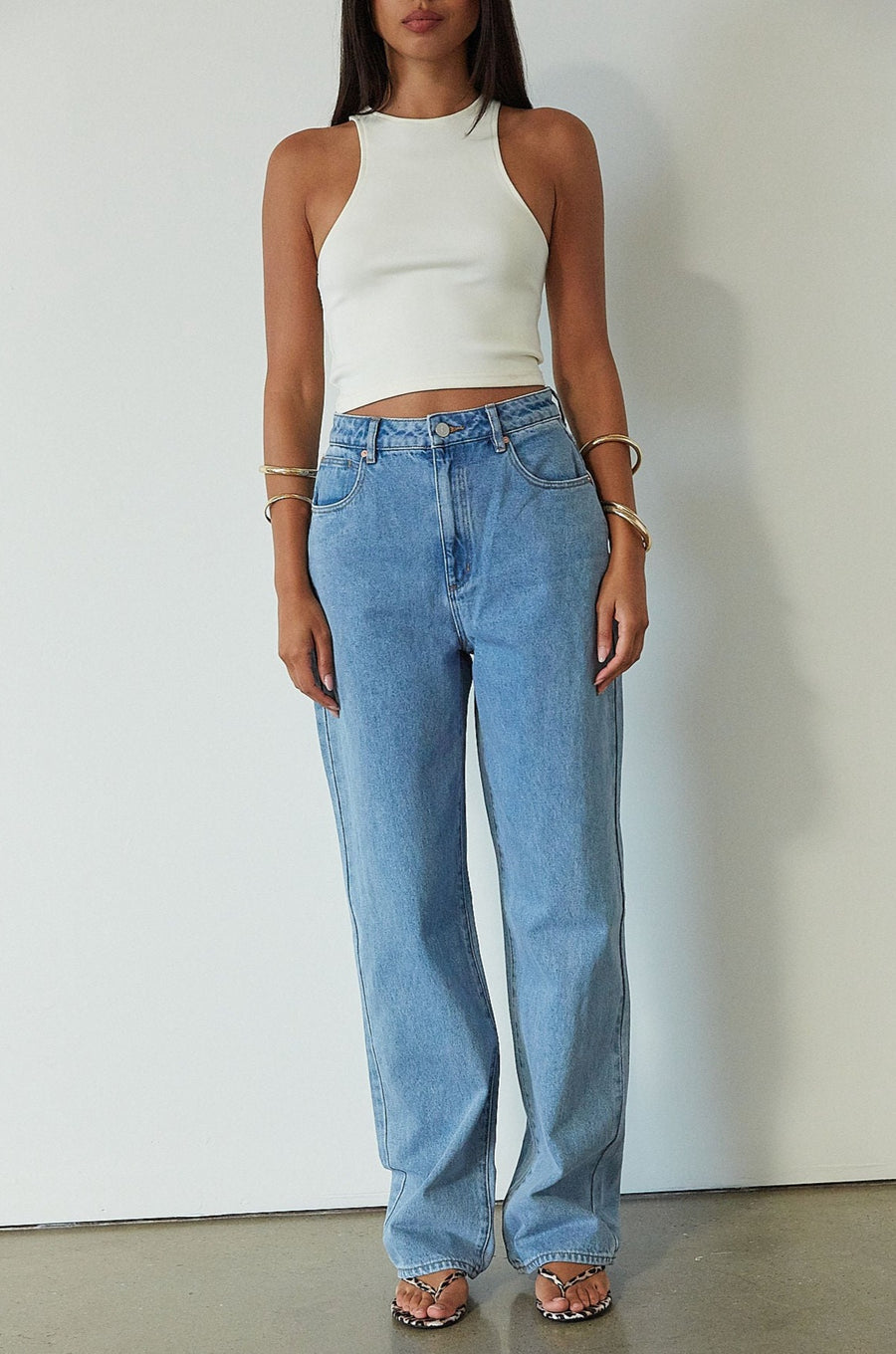Denim relaxed fit jeans. Button and zipper fly. Five pocket construction. Unlined. mid wash denim jeans.