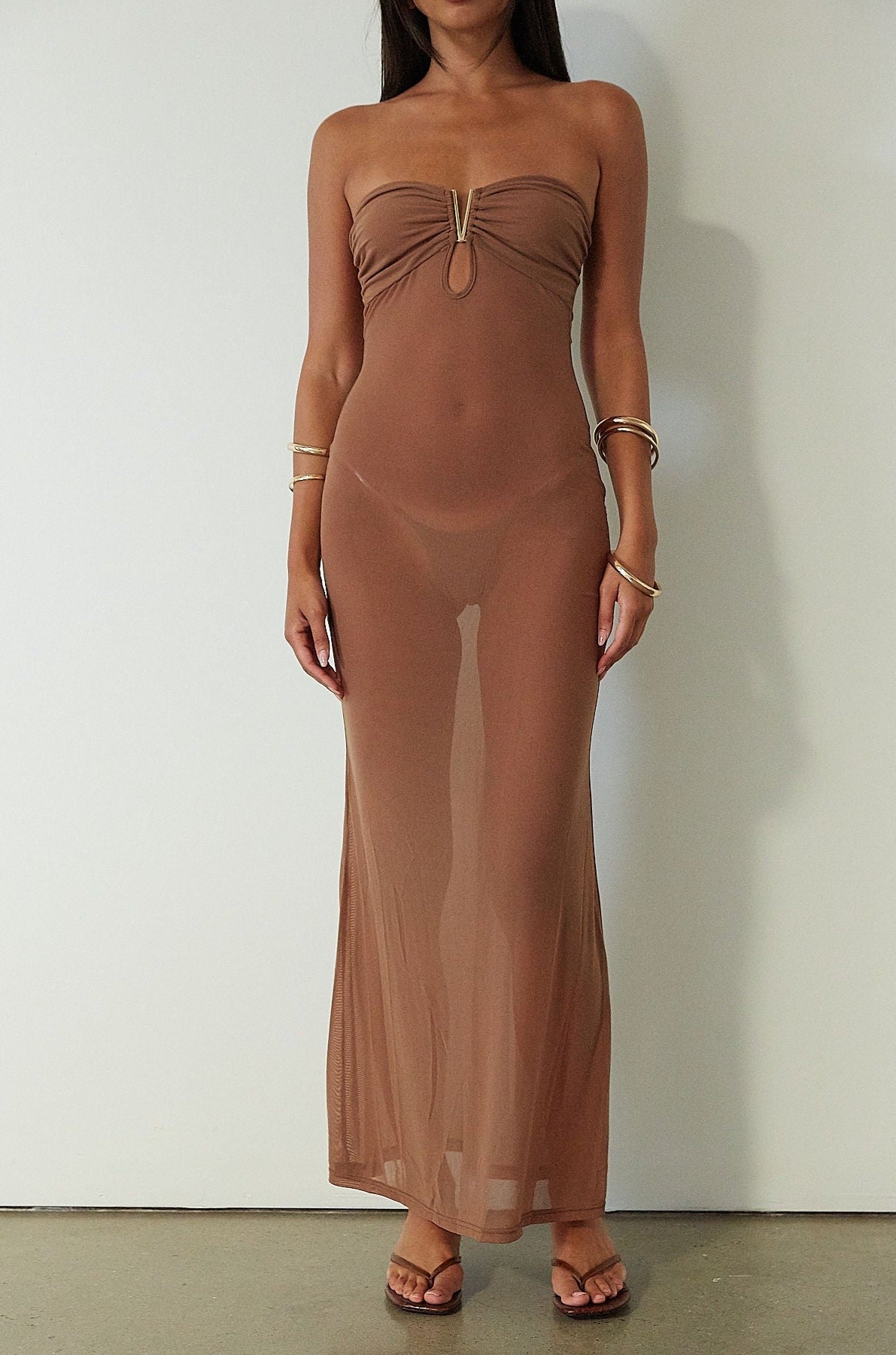 Knit mesh maxi dress. Strapless neckline. Front metal detail. Unlined. brown maxi dress. brown mesh maxi dress. mesh maxi dress. strapless maxi dress. mexico trip outfit. florida outift. evening dress. vacation dress. 