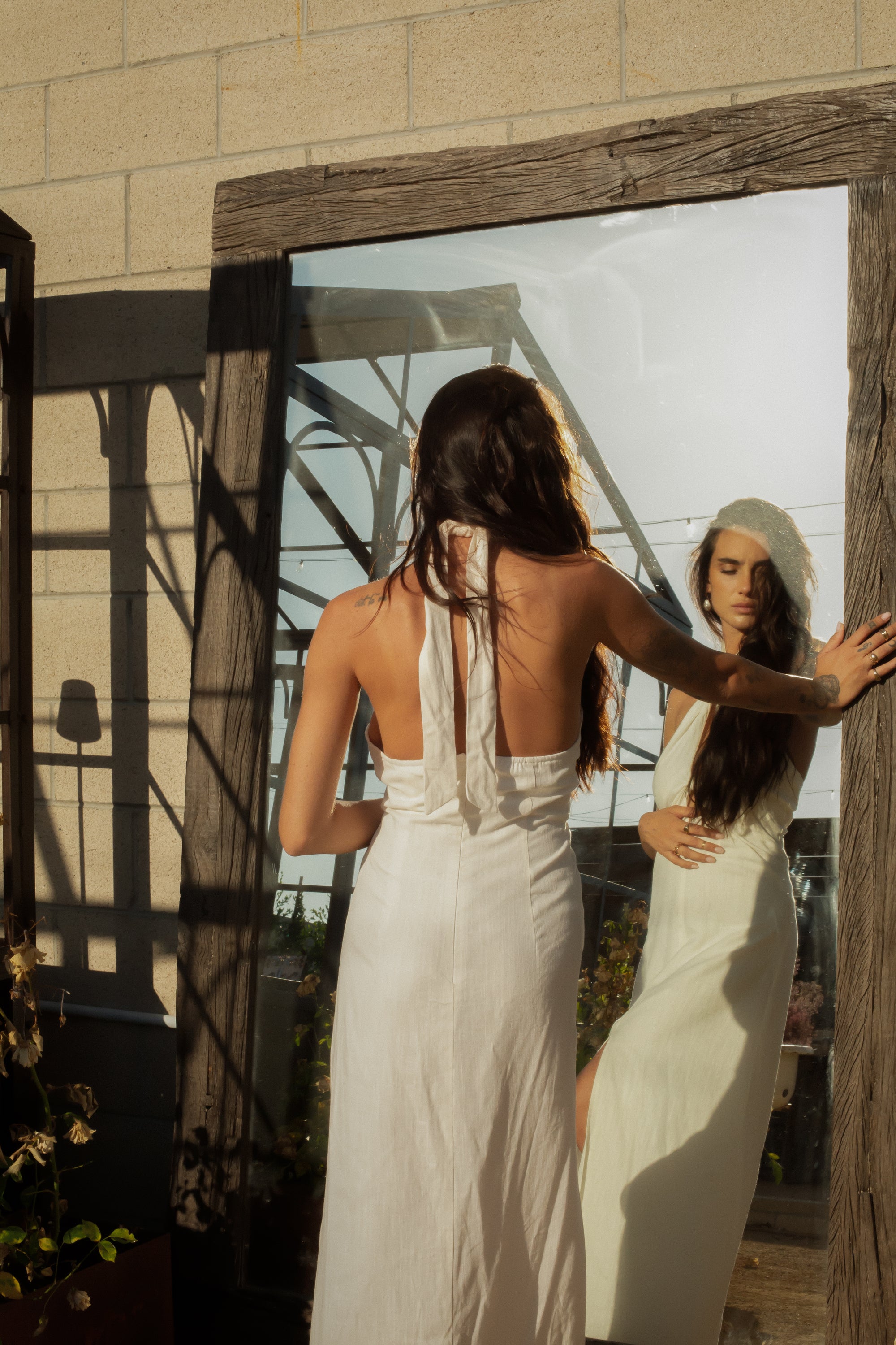 Woven maxi dress. Adjustable halter neckline with tie closure. Front slit. Back hook and eye and zipper closures. Fully lined. European summer. European summer dress. European summer aesthetic. Tuscany outfit inso. Tuscany aesthetic. Summer dress. white dress. white maxi dress. summer outfit. everyday dress. vacation dress. outfit to wear to tuscany. nice dinner dress. dinner dress. fancy dinner dress. white halter maxi dress. bride dress. engagement dress. engagement party dress