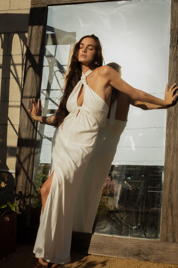 Woven maxi dress. Adjustable halter neckline with tie closure. Front slit. Back hook and eye and zipper closures. Fully lined. European summer. European summer dress. European summer aesthetic. Tuscany outfit inso. Tuscany aesthetic. Summer dress. white dress. white maxi dress. summer outfit. everyday dress. vacation dress. outfit to wear to tuscany. nice dinner dress. dinner dress. fancy dinner dress. white halter maxi dress. bride dress. engagement dress. engagement party dress