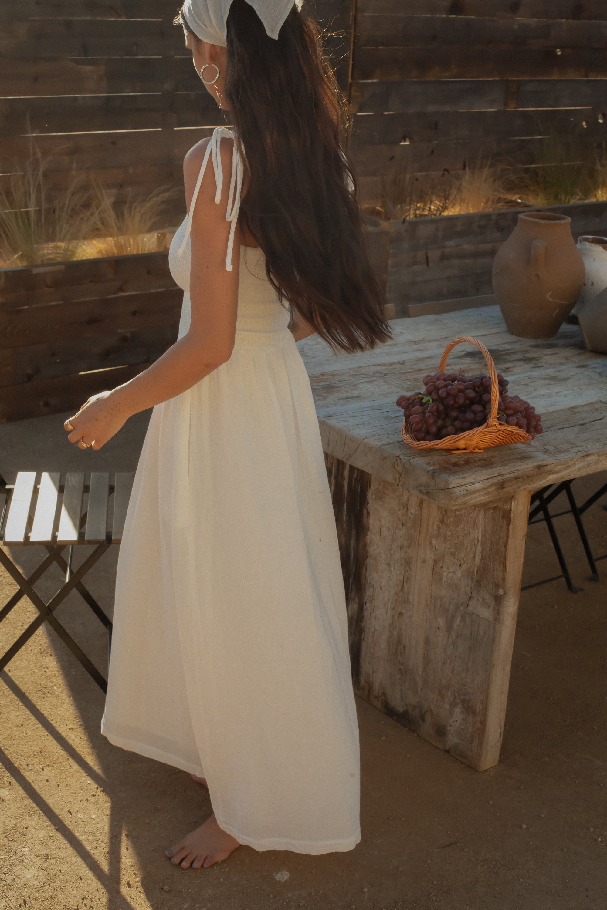 Sleeveless maxi dress. Elastic smocked bodice. Gauze skirt. Adjustable toe straps. Side pockets. Partially lined. European summer aesthetic. Tuscany outfit inso. Tuscany aesthetic. Summer dress. white maxi dress. summer outfit. everyday dress. vacation dress. outfit to wear to tuscany. day dress. white ruffled maxi dress. shoulder tie strap dress