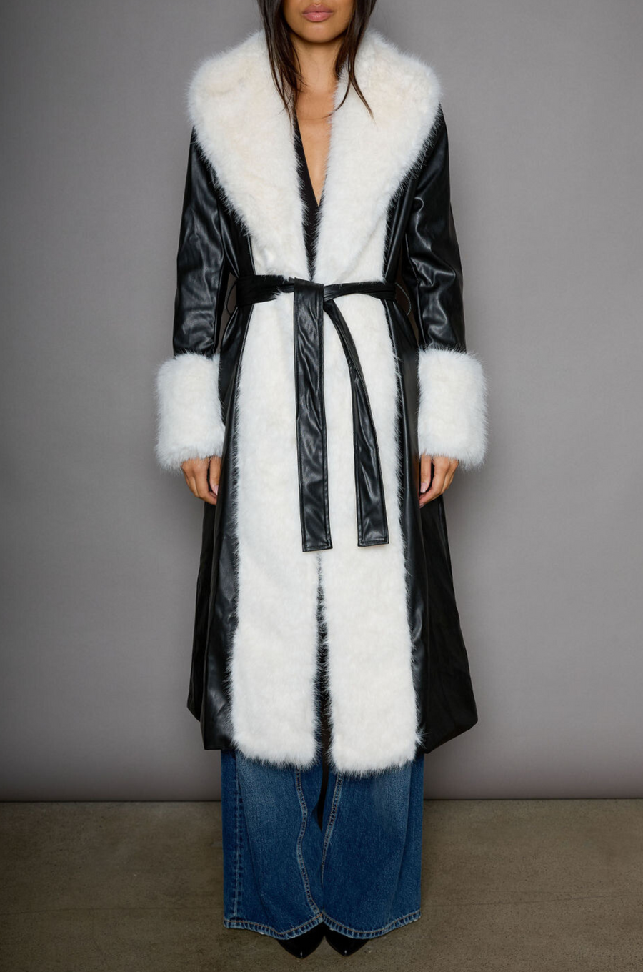 Faux leather longline coat. Faux fur trim. Collar neckline. Long sleeves. Open front. Tie waist. Fully lined. black leather coat. fur coat. coat for winter. cute leather coat. fashionable leather coat