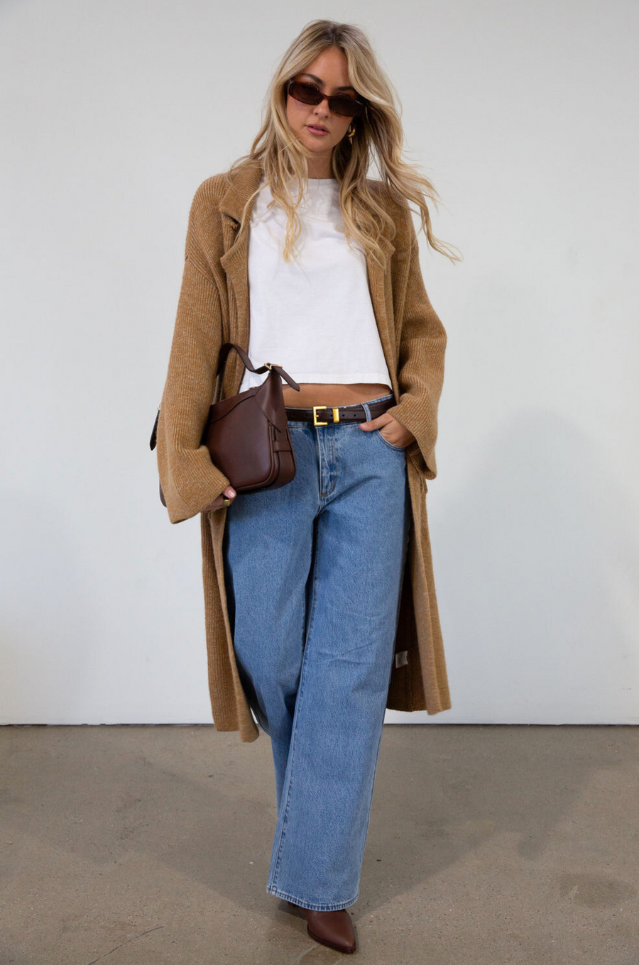 Fuzzy heather knit longline cardigan. Collar neckline. Long sleeves. Front pockets. Open front. Unlined. fall cardigan. tan long cardigan