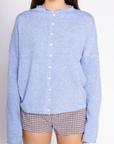 Fuzzy knit cardigan
Crewneck
Front button down closures
Long sleeves
Unlined
blue cardigan