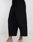 black Windbreaker material track pant
Mid rise
Ankle length
4 pocket construction
Adjustable elastic drawstring