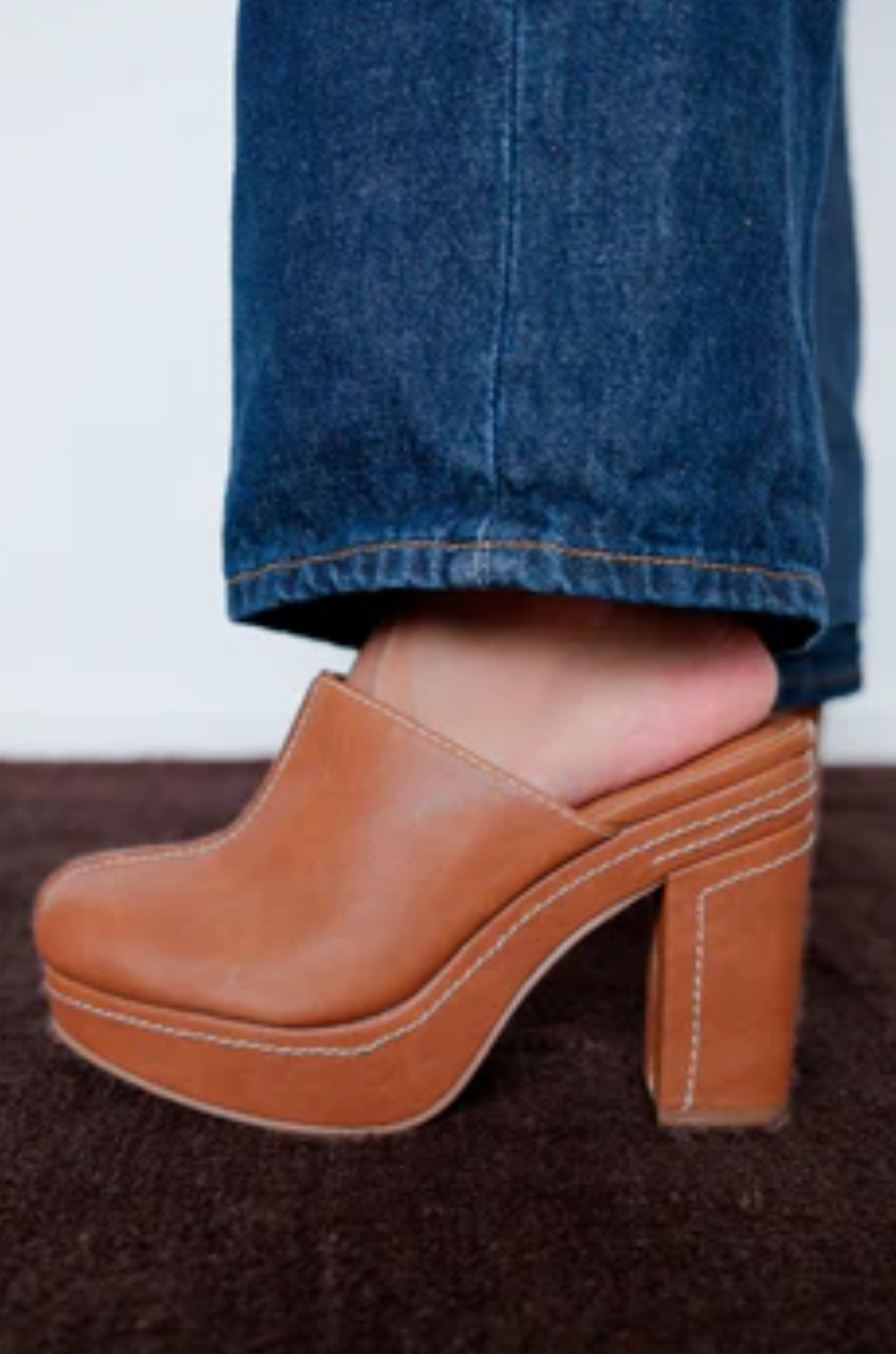 Vegan faux leather platform mule heel
Block heel and contrast stitching
Padded insole
Slip-on style
4.5" heel
1.25" platform
Faux leather
Manmade outsole
brown platform mule heel