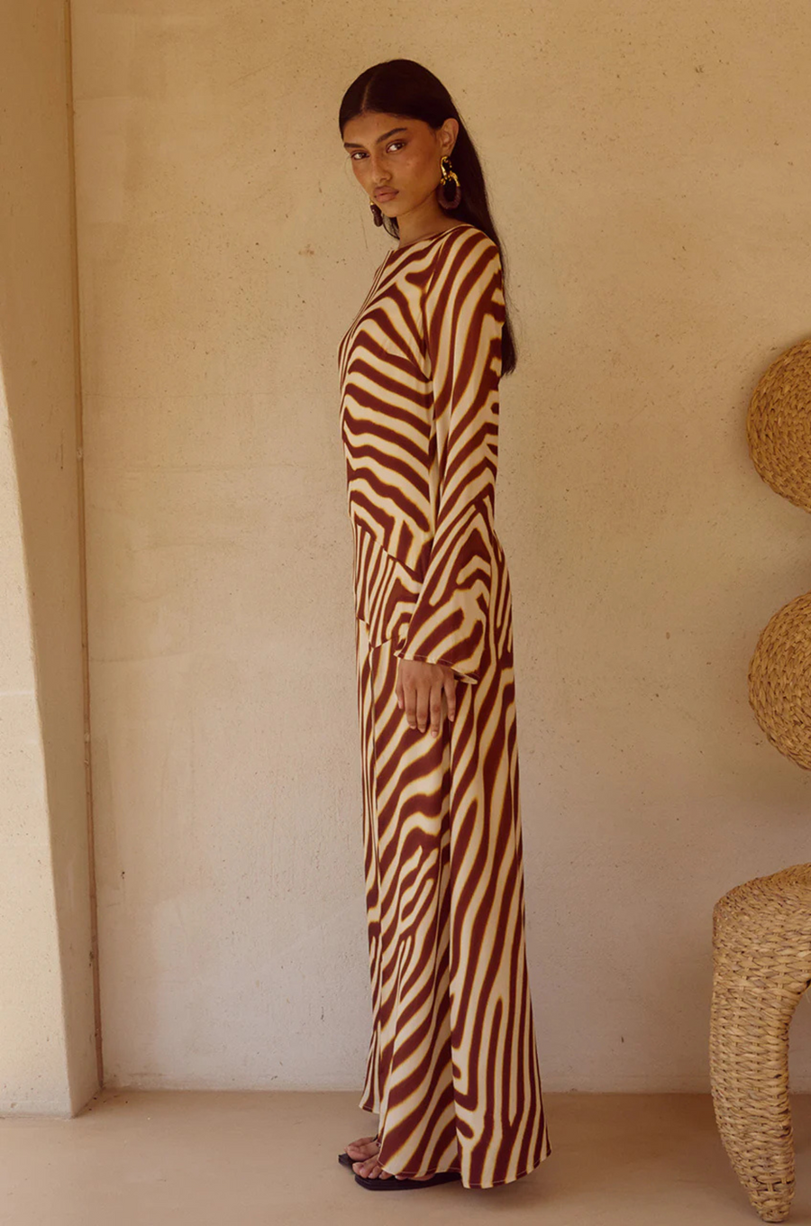 Animal printed long sleeve maxi dress
Front high slit 
Boat neckline
Adjustable back straps 
Open back Back zipper closure 
Lined, non-stretch 
zebra printed maxi dress 
long sleeve maxi dress