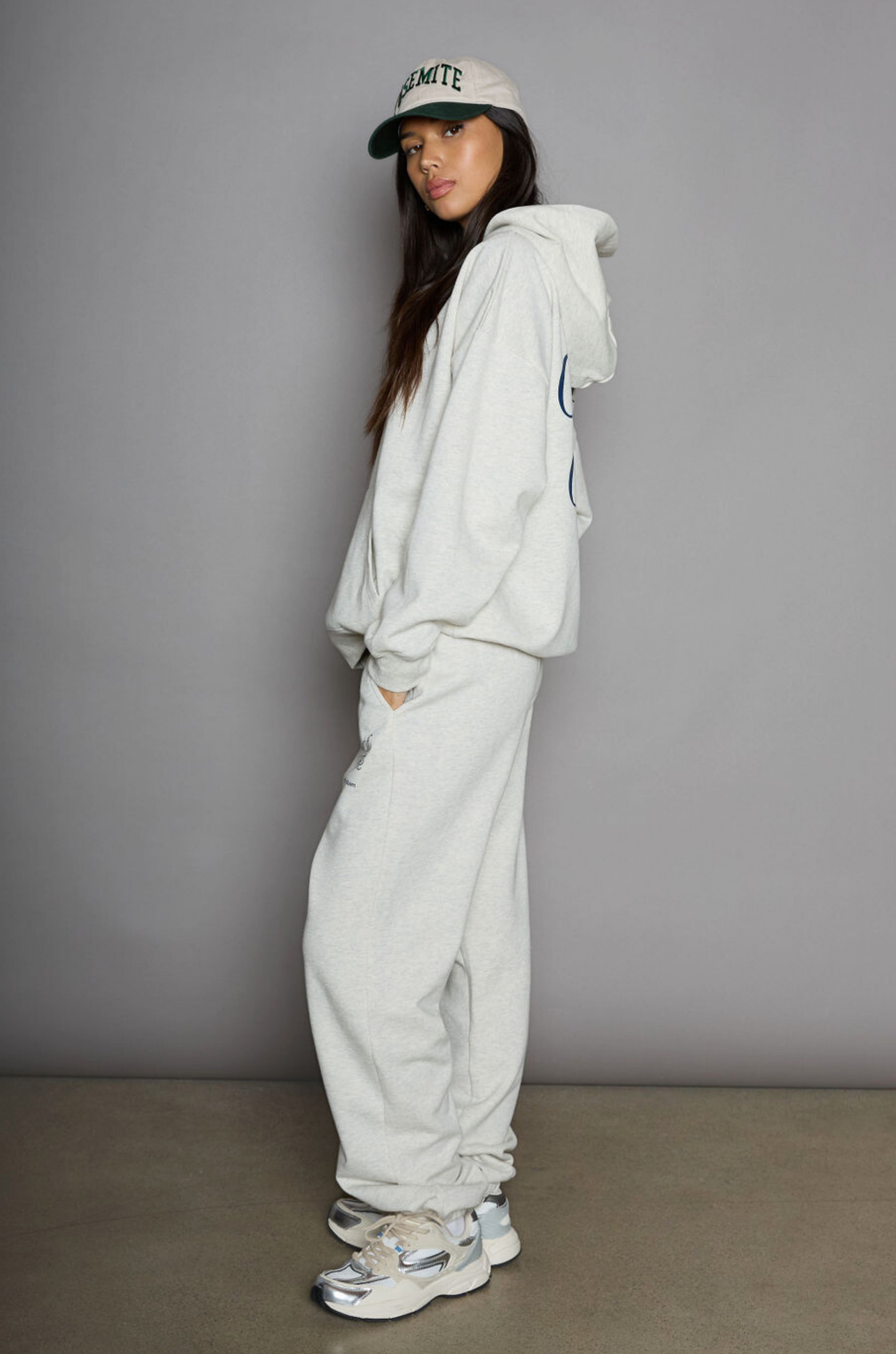 Graphic printed knit sweatset. Elastic waistband and leg openings. Side pockets. Fleece lining. hooded sweater. sweatpant. grey sweatset. out of office sweat set
