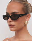brown Oval tort sunglasses
Gold hardware engraved with Banbé logo on outer left arm
Style details printed in gold foil on inner right arm
Scratch resistant/category 3/polarised lens
100% UV protection
Acetate frame
Width: 3.8", Lens Height: 1.1", Arm Length: 5.5", Nose Bridge: 0.7"