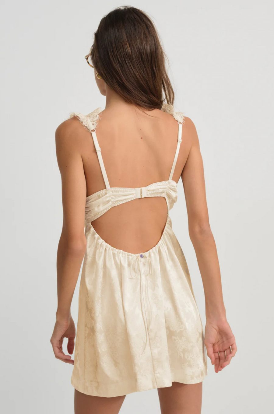 cream Satin slip mini dress with lace detailing
Crafted in a chic floral jacquard
Adorned with lace trims
Ruched underwire cups
Low drawstring back
Skinny chiffon tie bows and rosettes throughout
Unlined
Adjustable shoulder straps
Hook and eye closure at center-back
Polyester/Elastane
lingerie slip dress