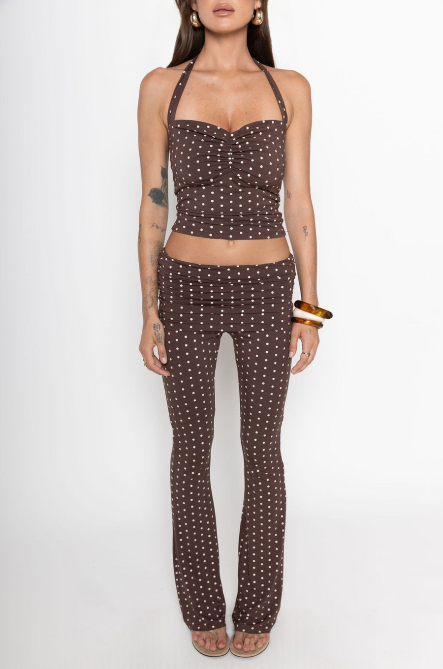 TOP

Polka dot halter top
Adjustable tie top
Ruched bust
Unlined
Length: 19"
Rayon/Spandex
BOTTOM

Polka dot pant
Fold over
Ruched sides
Flare bottom
Rayon/Spandex
Length: 39"
Runs small
brown polka dot tank top and pant set
