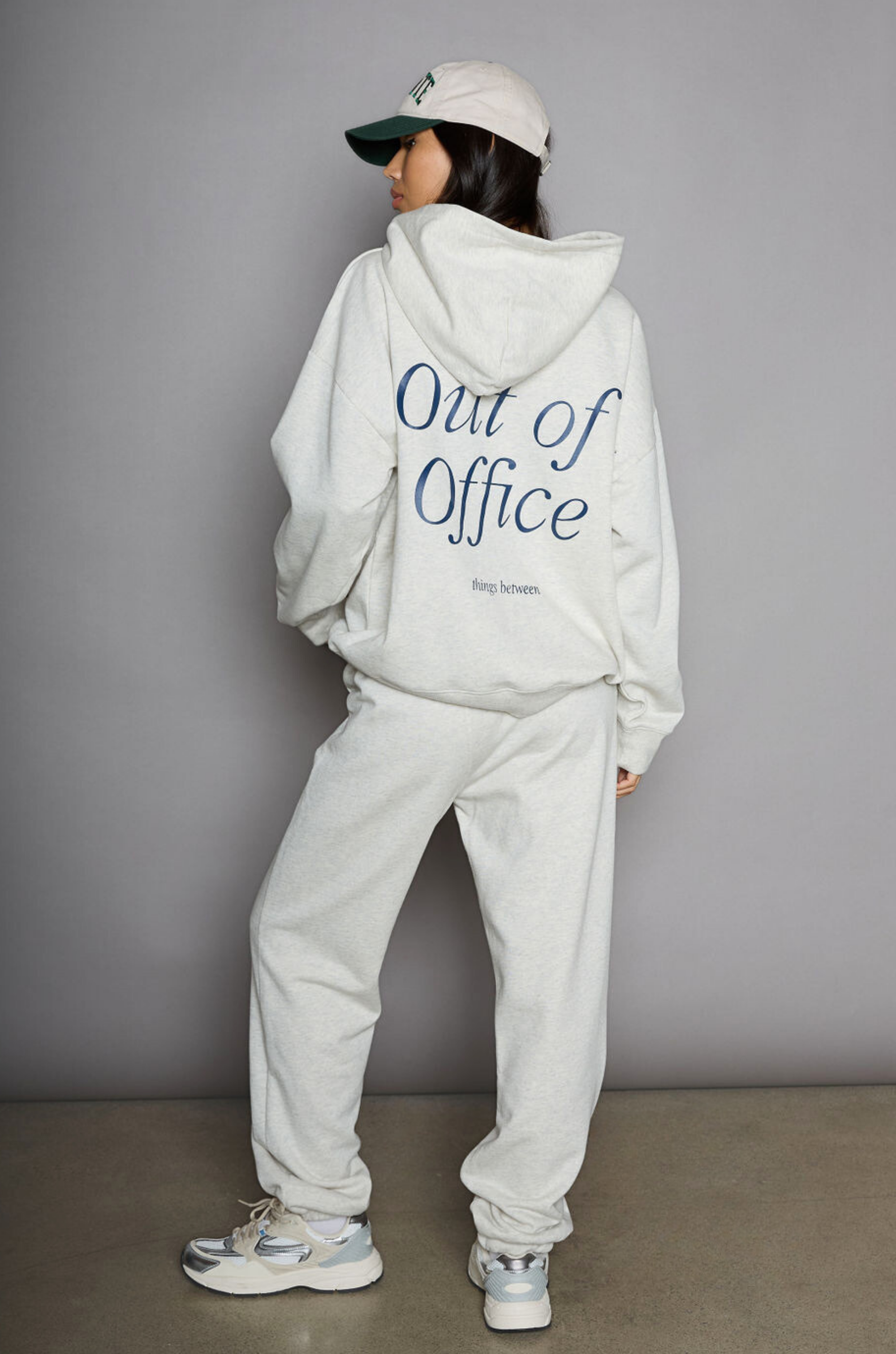 Graphic printed knit sweatset. Elastic waistband and leg openings. Side pockets. Fleece lining. hooded sweater. sweatpant. grey sweatset. out of office sweat set