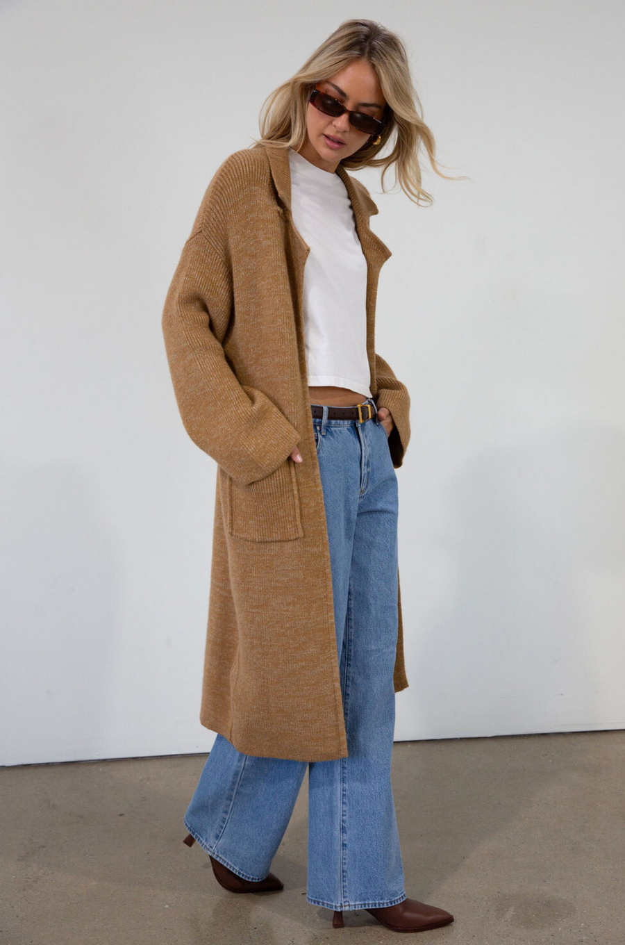 Fuzzy heather knit longline cardigan. Collar neckline. Long sleeves. Front pockets. Open front. Unlined. fall cardigan. tan long cardigan