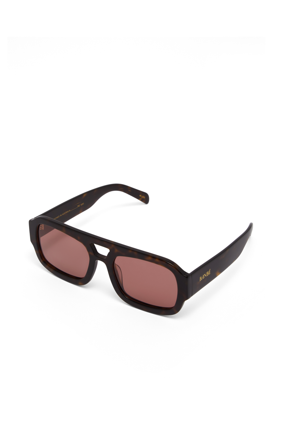 The Suki by Banbé are modern aviator sunglasses
Gold embossed Banbé logo on outer left arm
Style details printed in gold foil on inner right arm
Scratch resistant/category 3/polarized lens
100% UV protection
Acetate frame
Includes branded vegan case &amp; cleaning cloth
Designed in Australia
Width: 10.5cm / Lens Height: 5.1cm / Arm Length: 14cm / Nose Bridge: 3.5cm
pink lens sunglasses
tort and pink sunglasses