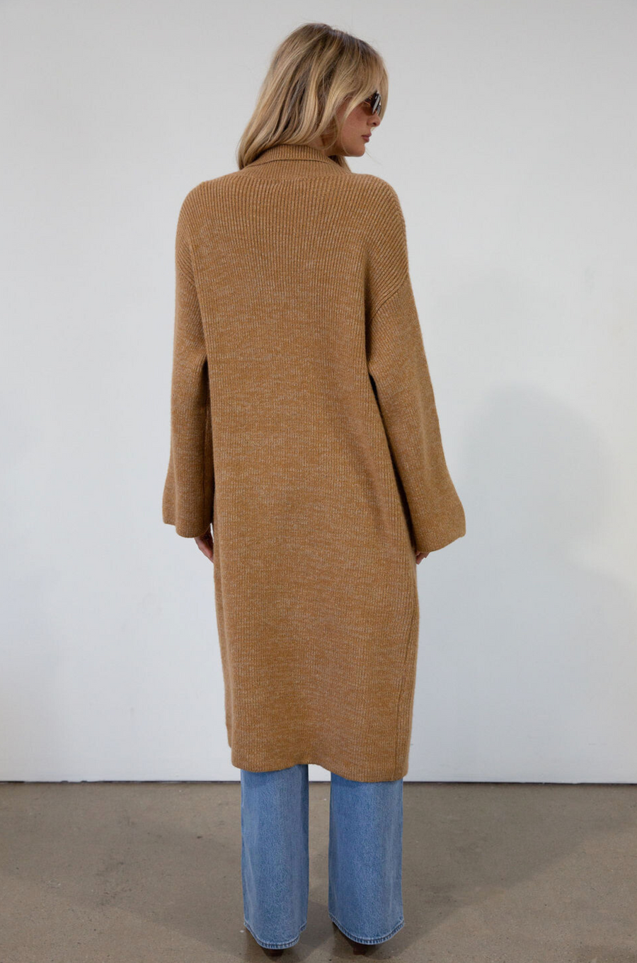 Fuzzy heather knit longline cardigan. Collar neckline. Long sleeves. Front pockets. Open front. Unlined. fall cardigan. tan long cardigan
