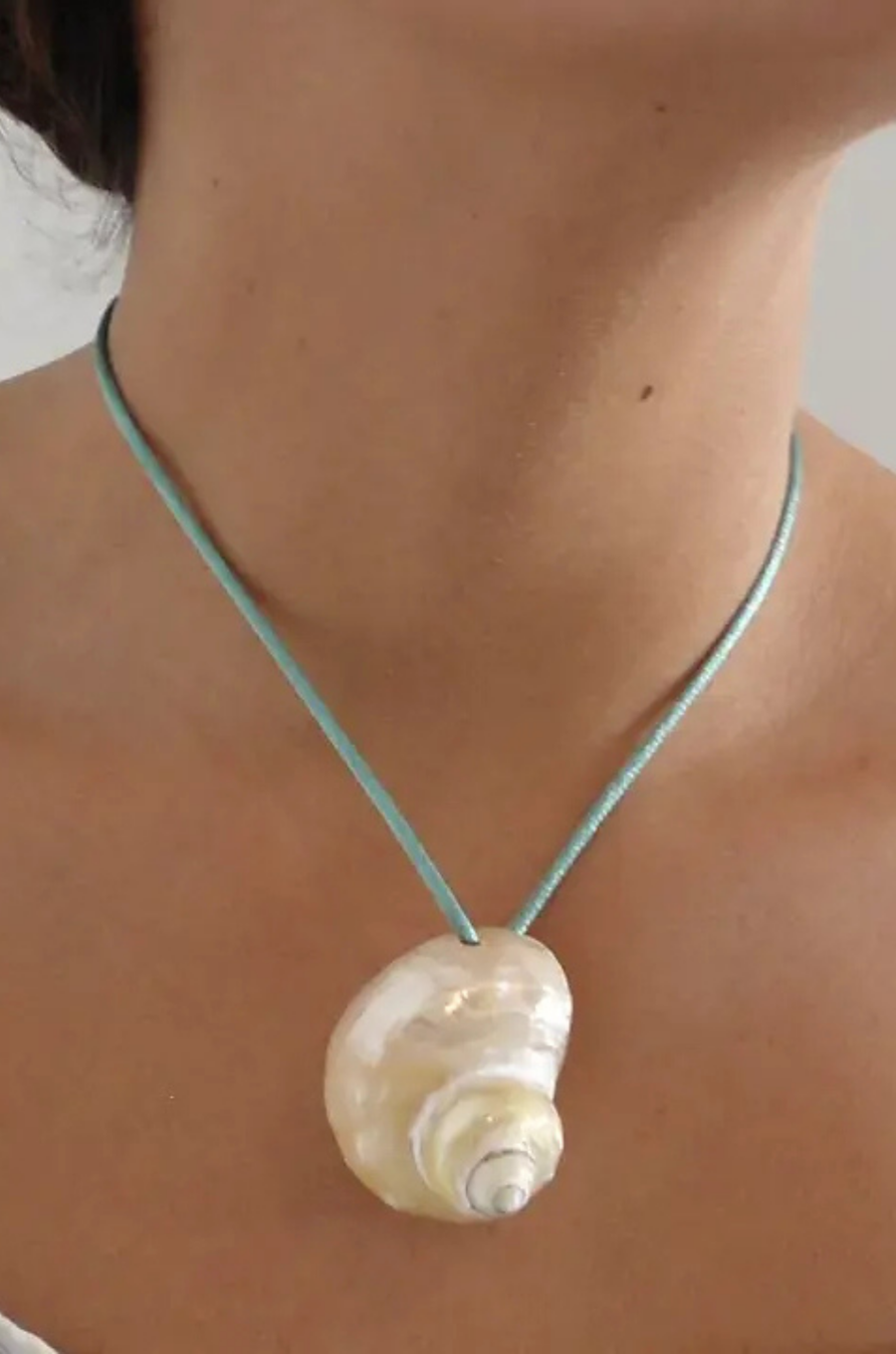 Turbo shell silk cord necklace
Polished and hand-drilled
Silk cord with gold plated beads
Can be worn multiple ways
Length: 26"
Turbo shell approx. 1.5"
Size color and shape of shell may vary slightly