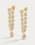Prong-and-bezel style earrings
Available in 14kt gold plated brass or Rhodium plated brass
Stones are white CZs,&nbsp; measuring 3.0–3.5mm round and 6x4mm pear
Post fastening for pierced ears
Sold as a pair
gold droop earrings
fancy earrings