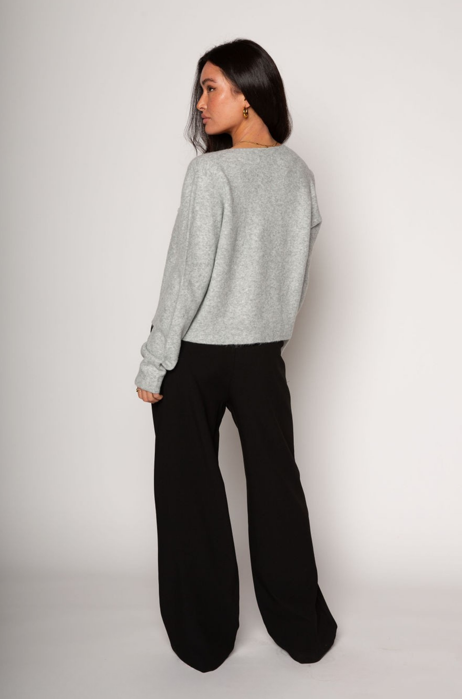 Black stretch trouser pants. Trimmed waist. Button and zipper fly. Side pockets. Faux back pockets. Unlined. layered slacks