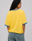 Game on. Keep your eye on the ball in this OS Ringer Tee designed in colors inspired by the Team Brasil jersey. Featuring an athletic influence with rib contrast along the neckline and arms.
Oversized fit and length, accented with dropped shoulders
Available in just one size
Length: 27.5"
Cotton
yellow brazil brasil world cup jersey tee